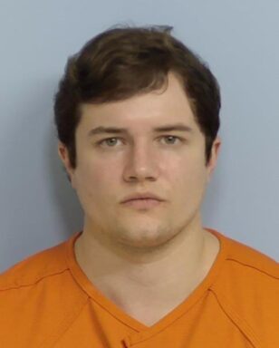 Mug shot of a white male with orange jumpsuit